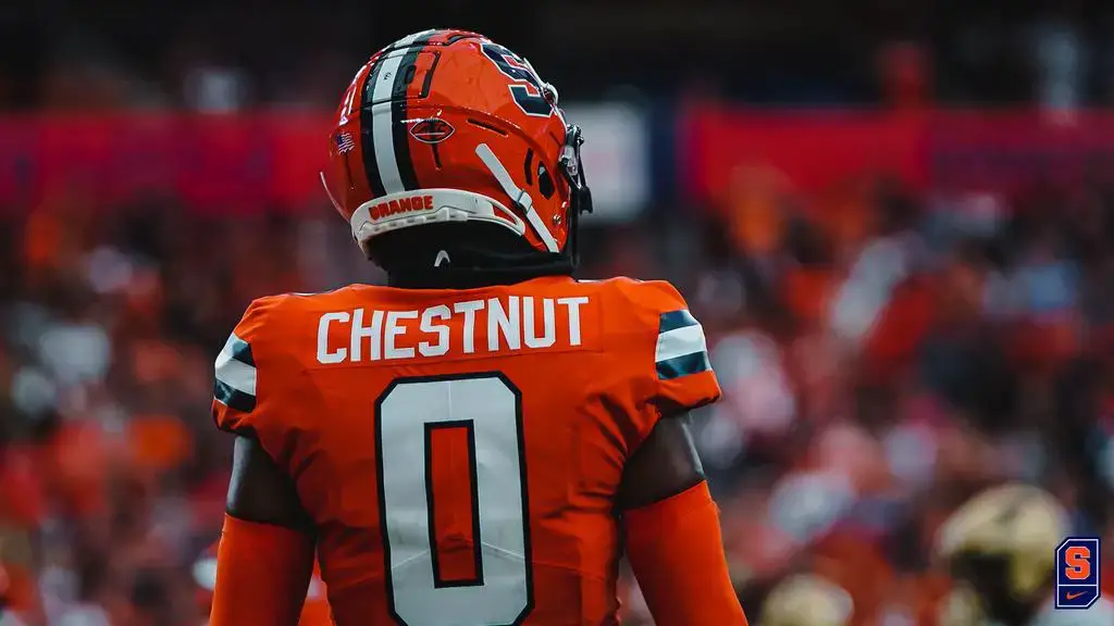 Syracuse football wearing white helmets, orange jerseys, white